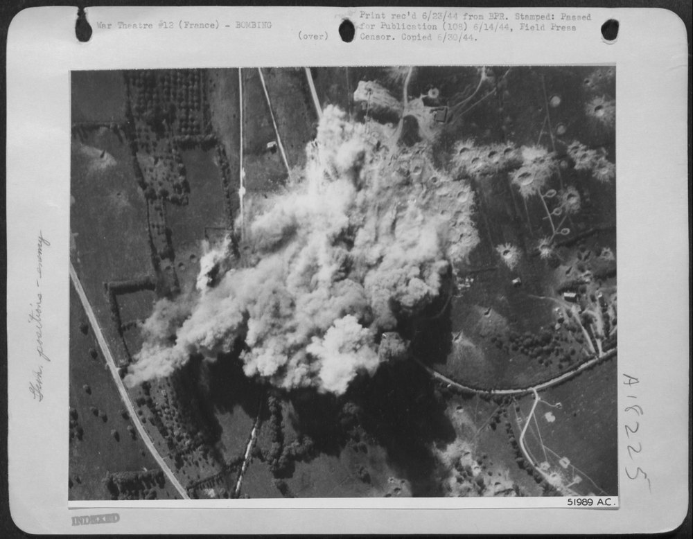 Smoke billows up from a shore battery in France, liquidated by Ninth