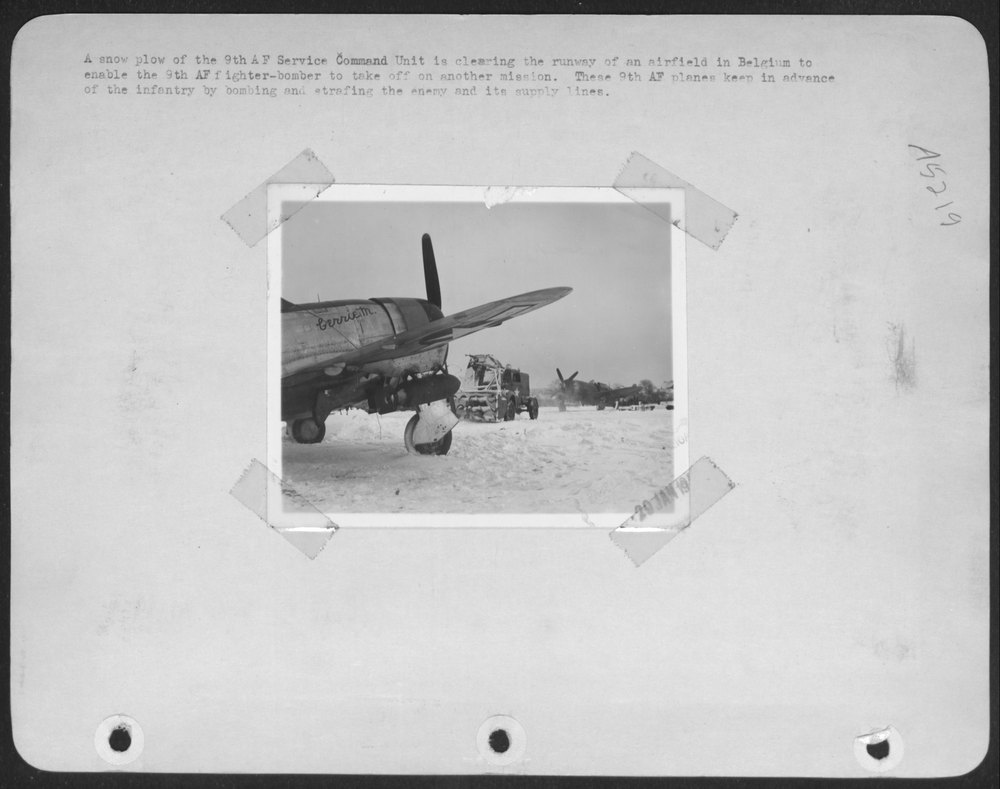 Snow plow clearing airfield in Belgium