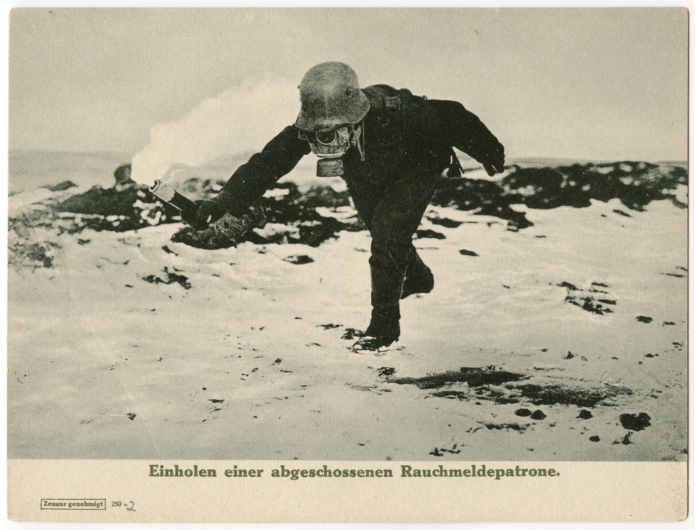 Soldier retrieving smoke signal cartridge