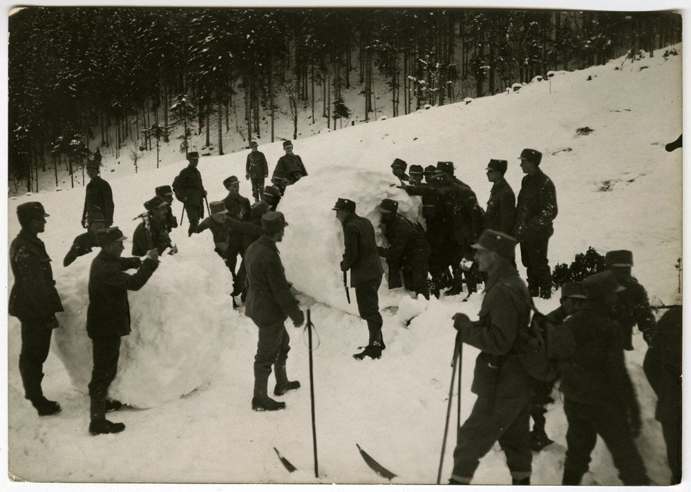 Soldiers building a snow wall in a forest