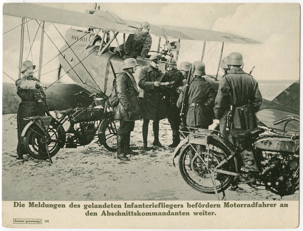 Soldiers with biplane and motorcycles on dirt field