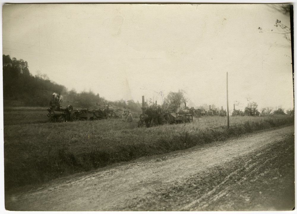 Steam tractors in a grassy field