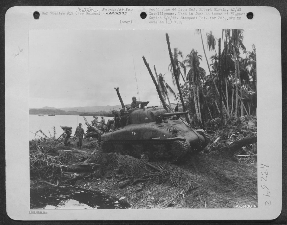 Tank rumbles inland to attack Jap positions