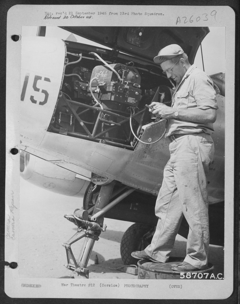 Technician at work in P-38 nose Corsica