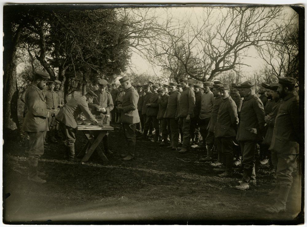 Troops receiving cigars in the field