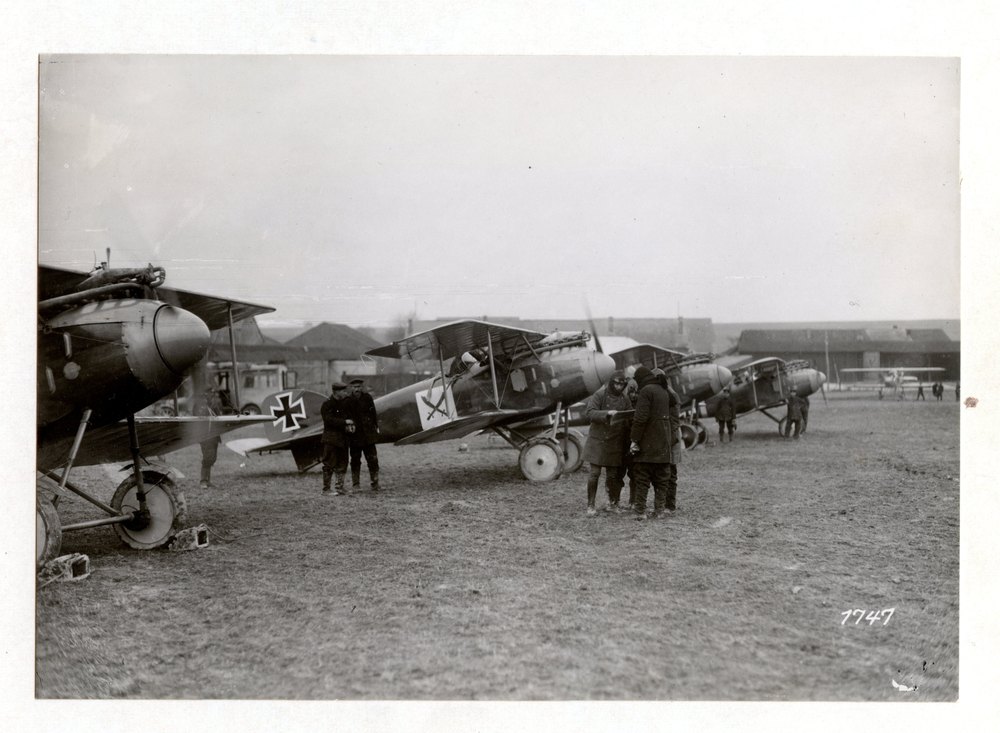 With a pursuit squadron in the West. The aviators during a conference before the flight. Champagne