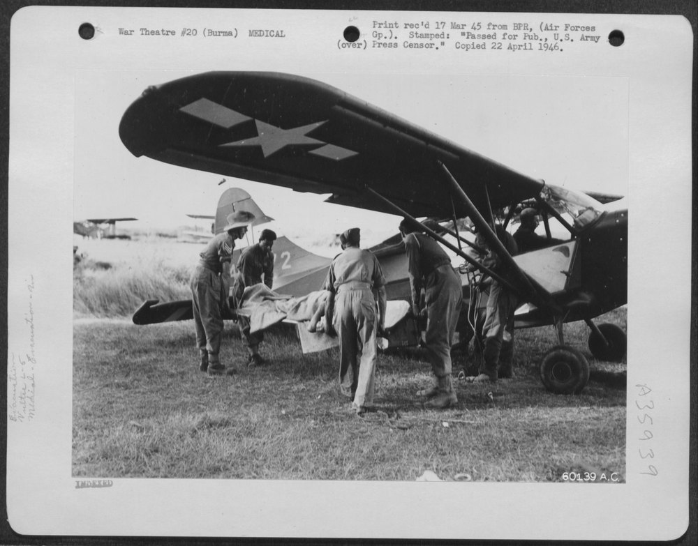 Wounded British Soldier Loaded On Vultee L-5 Plane
